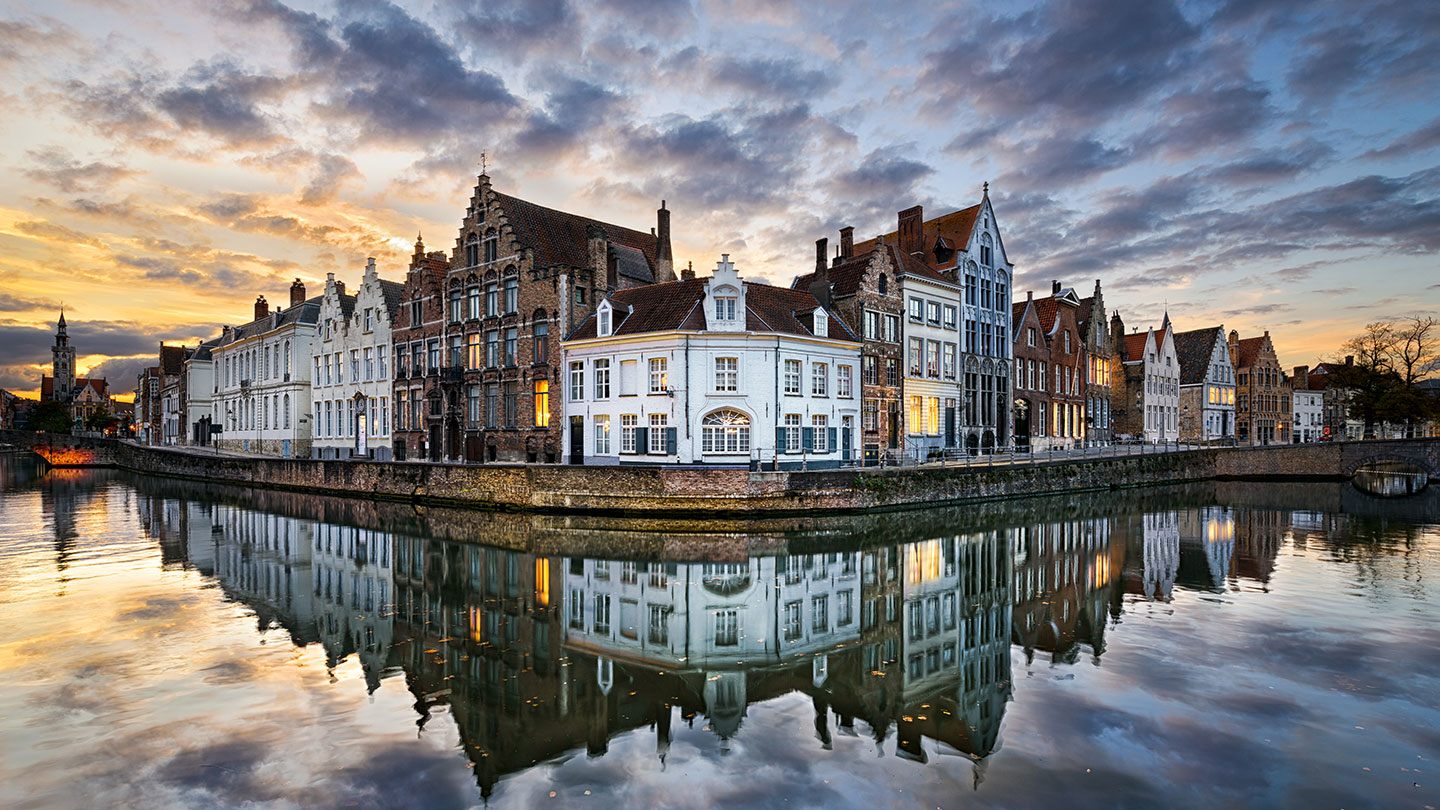 Cloudy waterfront view of historic Belgium houses