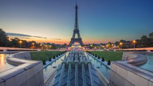 Landscape shot of Eiffel Tower at sunset with blue skies