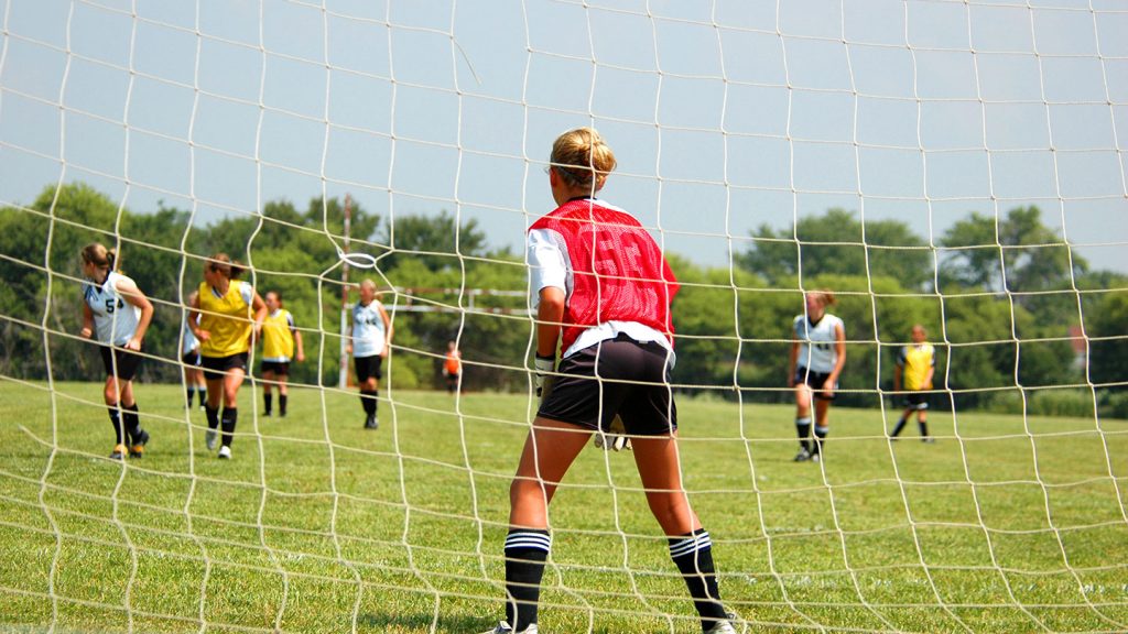 Girl in goal playing football