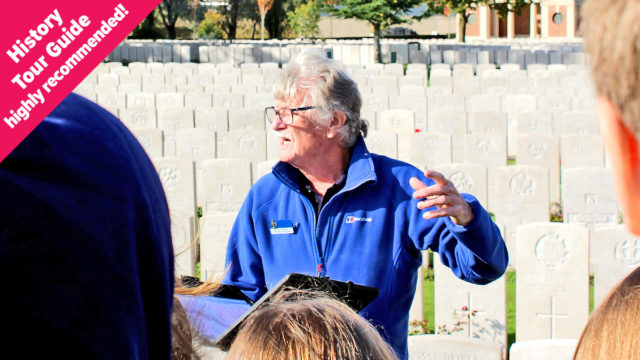 Trevor our history tour guide teaching students at a war memorial