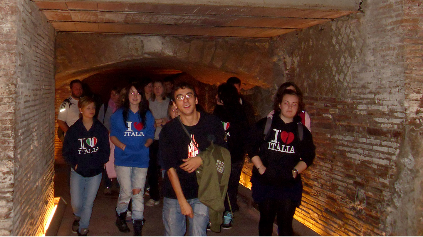 Students walking through an underground tour in Naples