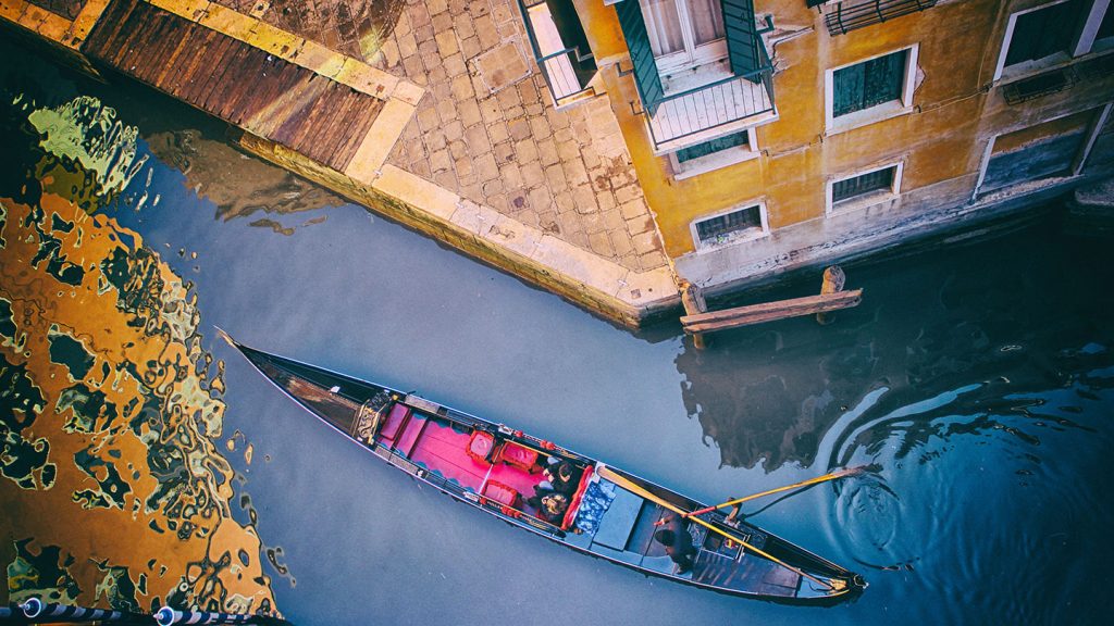 Gondola on the canal in Venice surrounded by buildings
