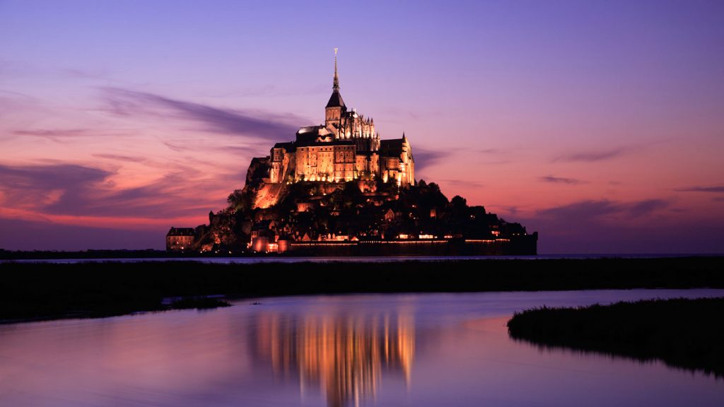 A beautiful dusk view of Mont St Michael in Normandy, France