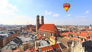 Sky top view of a sunny Munich and hot air balloon