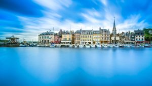 A coastal view of Normandy with its historic buildings and blue waters
