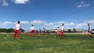 Football team playing in white and red kit