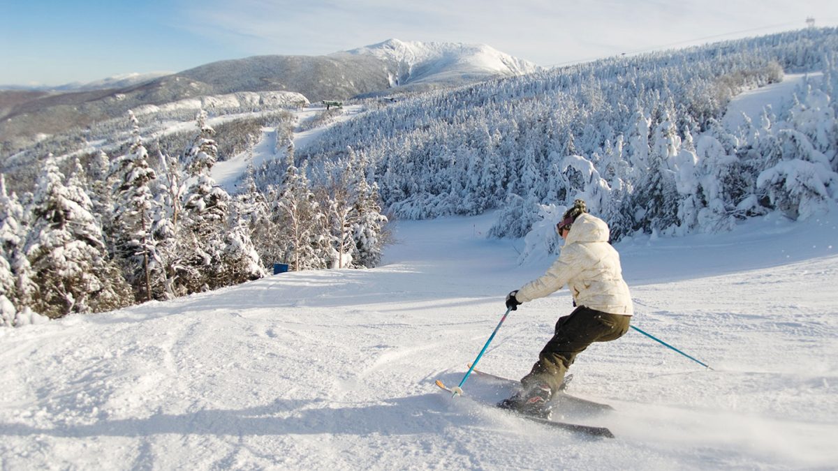 Female skier heading down the slopes of Cannon