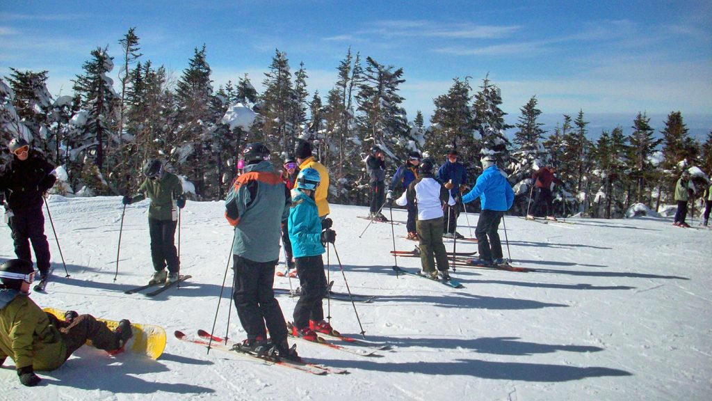 Group of skiers taking a break in the sun at Cannon