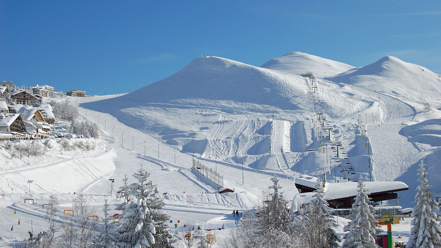 Beautiful sunny landscape of the fresh snow and peaks of Prato Nevoso, Italy