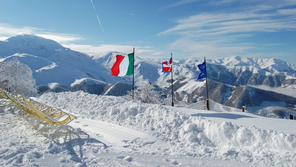 Landscape view of the mountains and snow with national flags at Prato Nevoso Italy