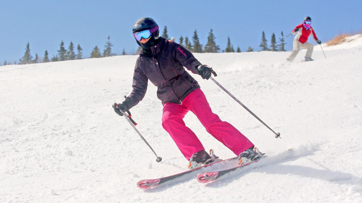 Lady in pink pants skiing down the slopes of Sugarloaf