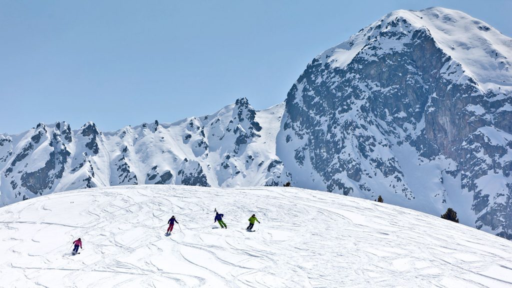 Group of skiers enjoying the the slopes on a sunny day in Vallnord, Italy