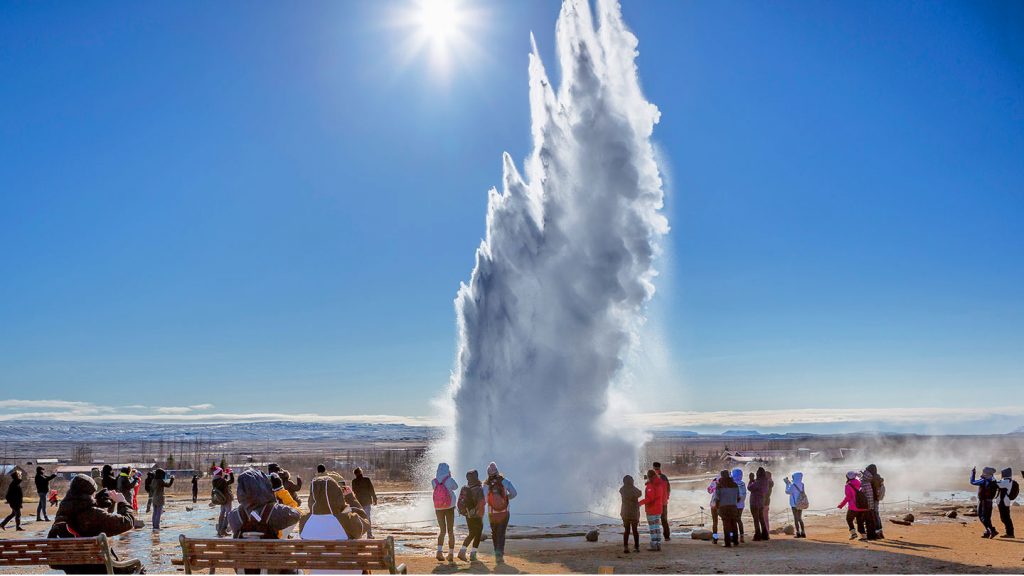 Students stood beside an erupting geyser on a Geography School Trip to Iceland