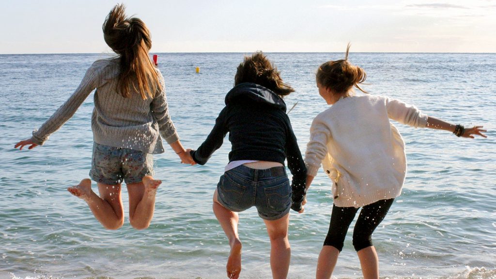 Students having fun on beach in Barcelona, Costa Brava, Spain