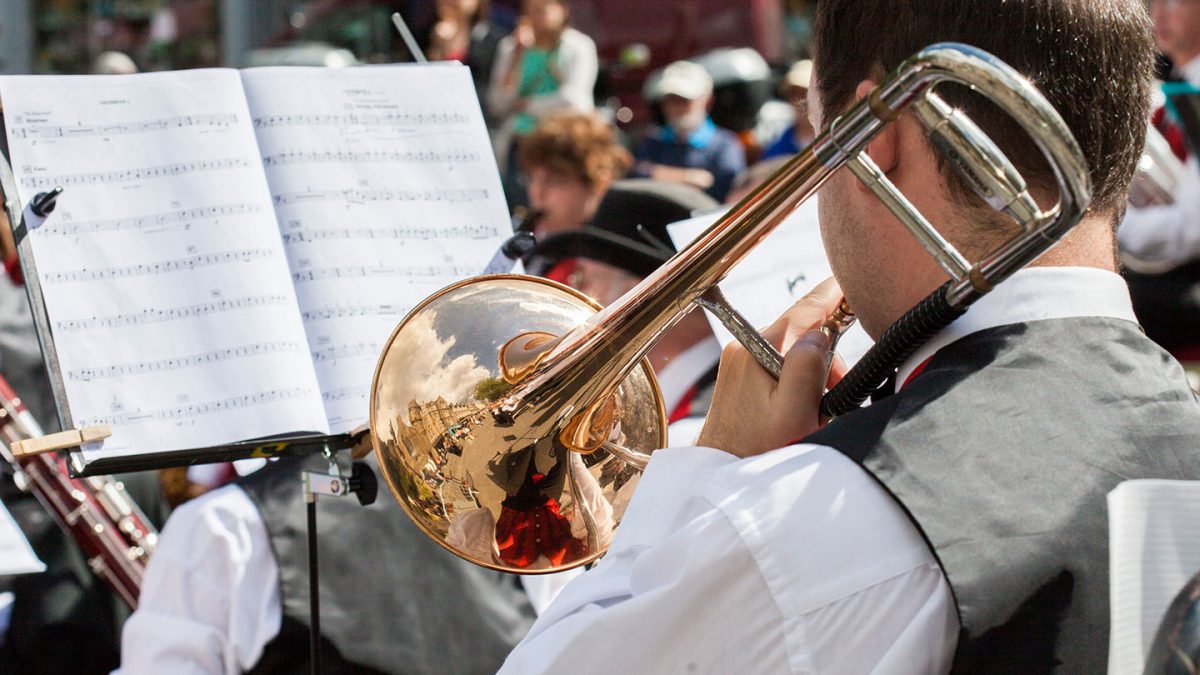 Trombone playing reading and playing music on a concert tour