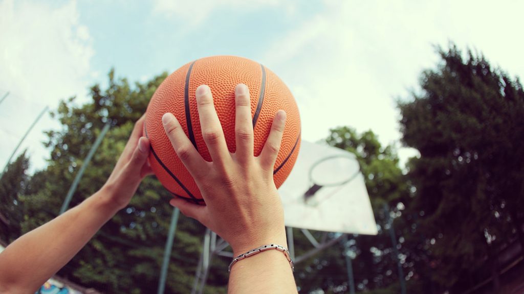 A basketballer goes to shoot a hoop