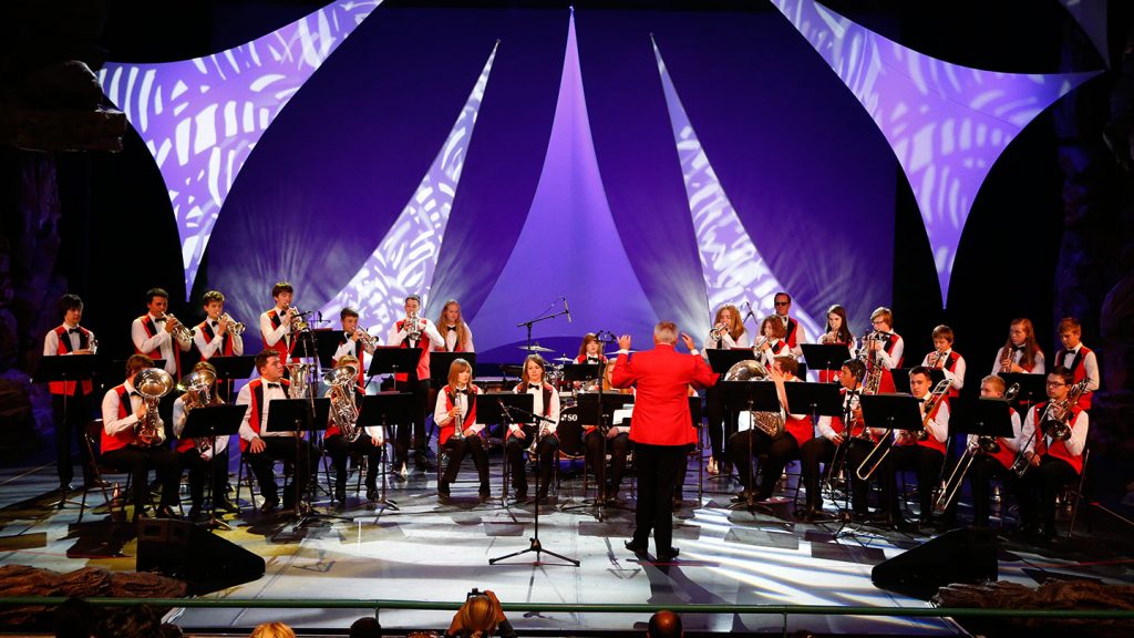 An orchestra performing on a stage