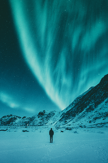 The Northern Lights seen behind a mountain in Iceland