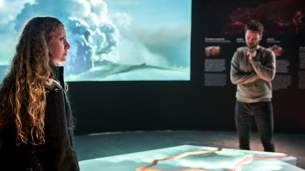 Young man and woman enjoying an exhibition at Perlan, Iceland