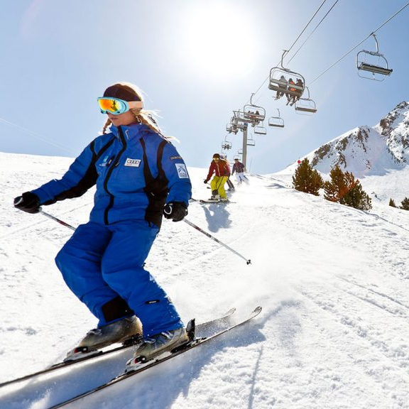 How To Pick The Perfect School Ski Resort: people skier under a ski lift