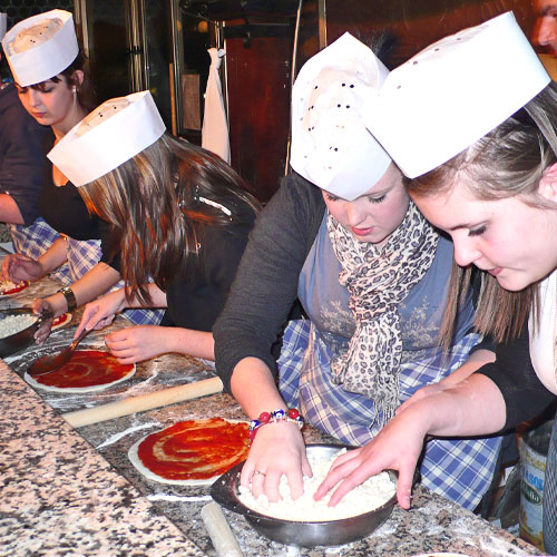 School pupils making pizza on a Food Technology school trip