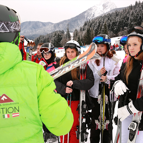 ski instructor teaching group of children on school ski trips to France