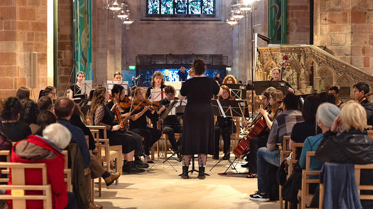 10 Best Ways on How To Prepare for Your Music Tour: a school concert tour ensemble performing before an audience