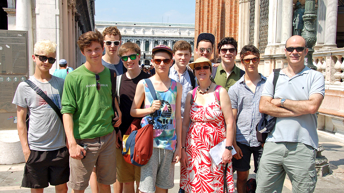 9 top tips on how to plan the perfect school concert tour: Students and staff posing in a sunny location