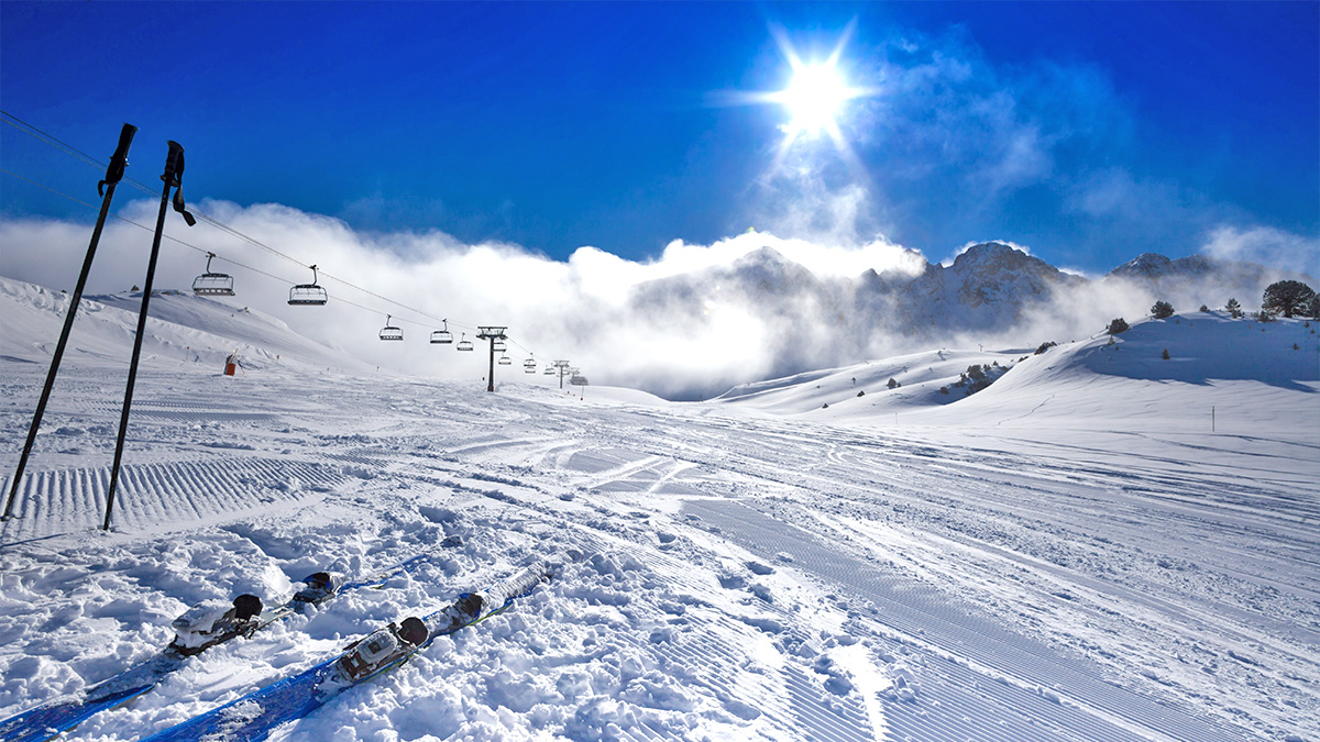 Grandvalira: Andorra’s Paradise Ski Resort - skis on a slope with ski lifts travelling up and down in andorra