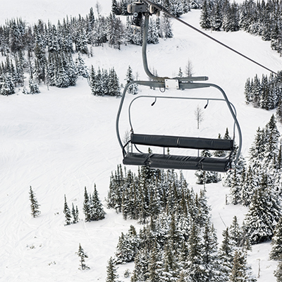 School Skiing in Andorra and Everything You Need To Know: Empty ski lift travelling up a snowy ski slope