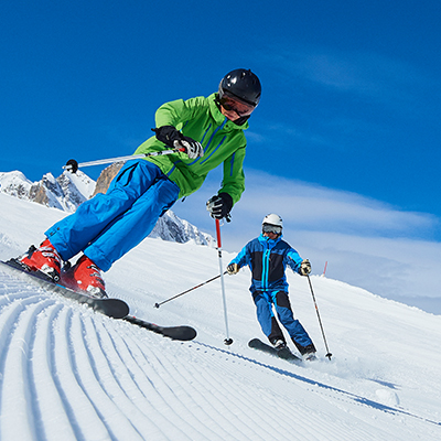 two people skiing down a snowy ski slope