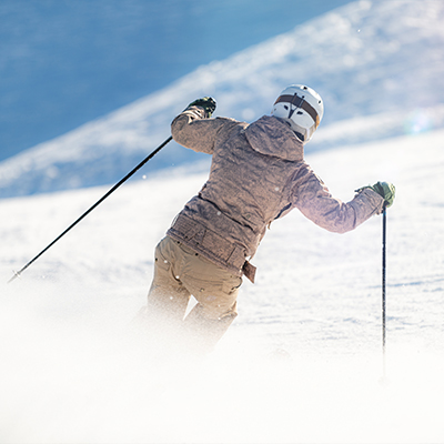 Young person skiing down a slope