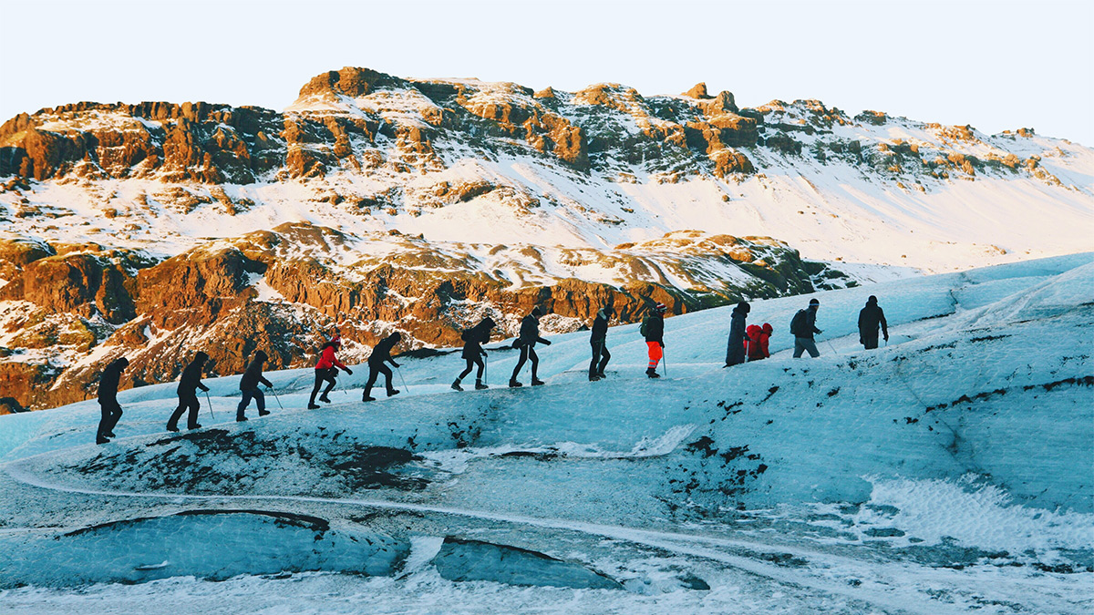 People hiking along a glacier in Iceland