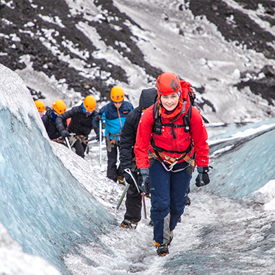 Students hiking with a guide along the Sölheimajökull glacier in Iceland