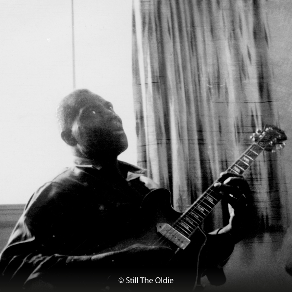 Old faulty polaroid image of Howlin' Wolf playing guitar, image copyright: Still The Oldie (Flickr)