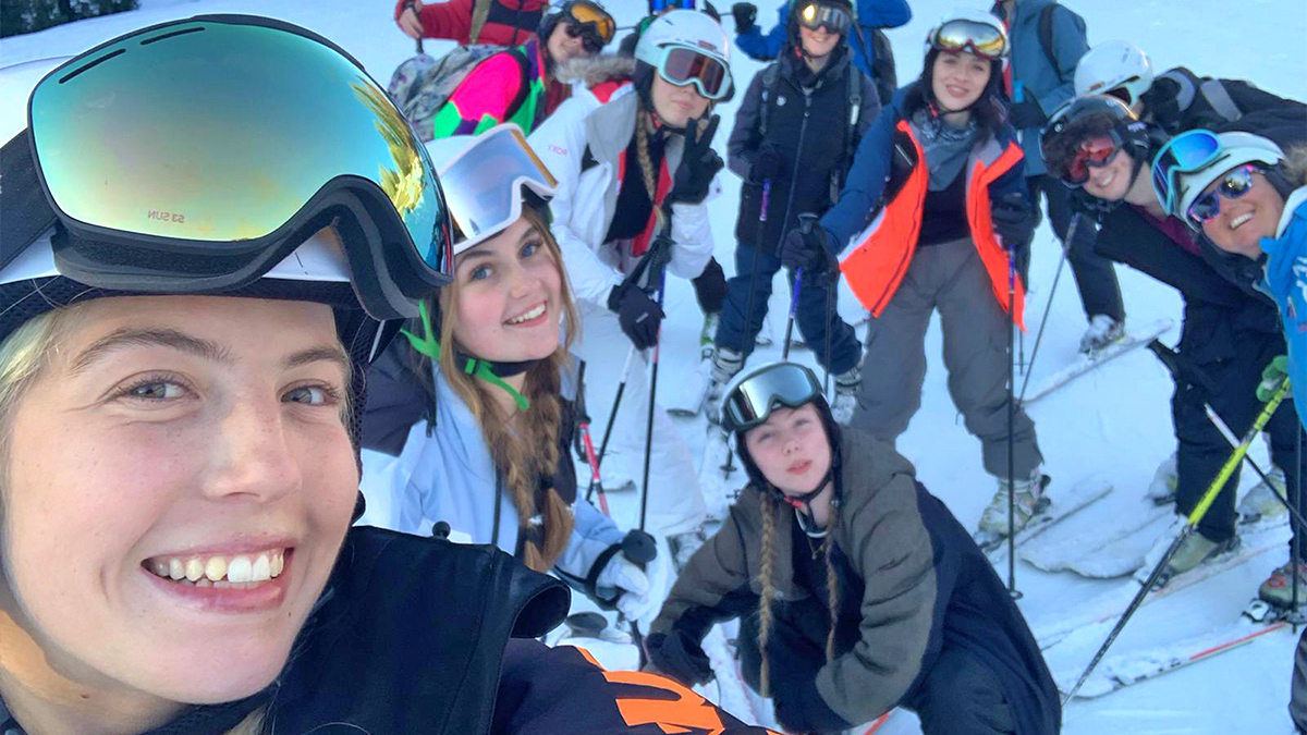 Rayburn Ski Rep Ella, posing for a selfie with a group of young skiers on the slopes of Folgaria, Italy in the February half-term ski season 2023