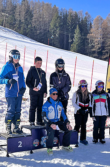 Young first time skiers enjoying an awards ceremony on the slopes in Italy in the February half-term ski season 2023