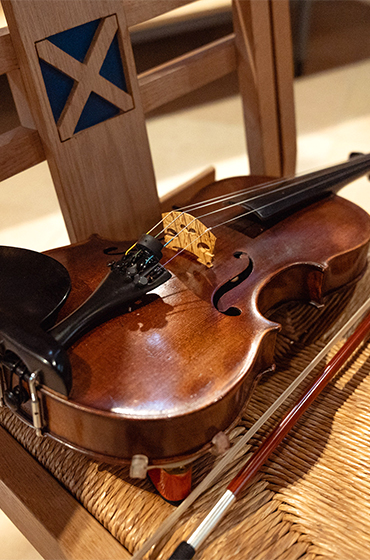 A violin placed on a chair on a concert tour