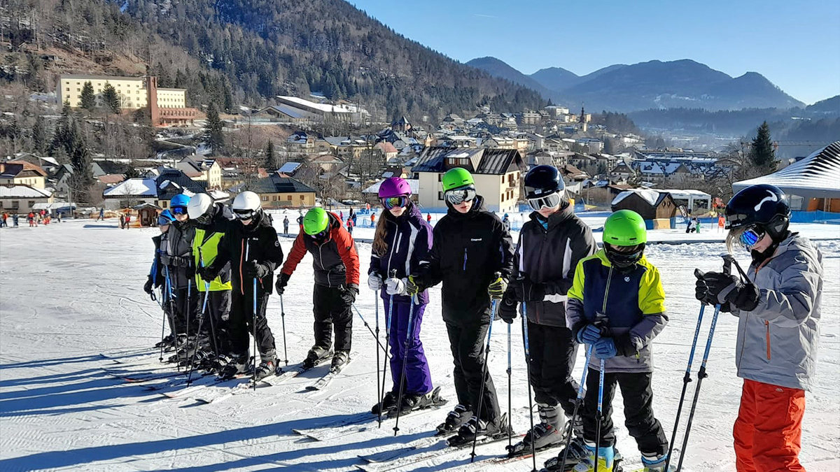 A group of young skiers taking instruction on the slopes in Tarvisio, Italy in the February half-term ski season 2023