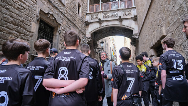 Students listen to a guide on a walking tour through the streets of Barcelona