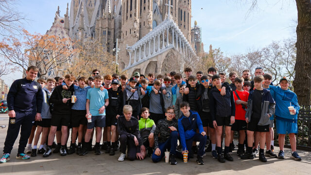 Mosslands School students and teachers pose in front of La Sagrada Familia on a football trip arranged by Rayburn Tours