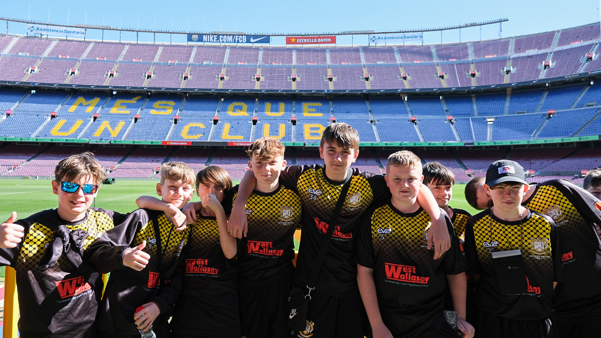 Students pose pitch side at FC Barcelona Nou Camp stadium