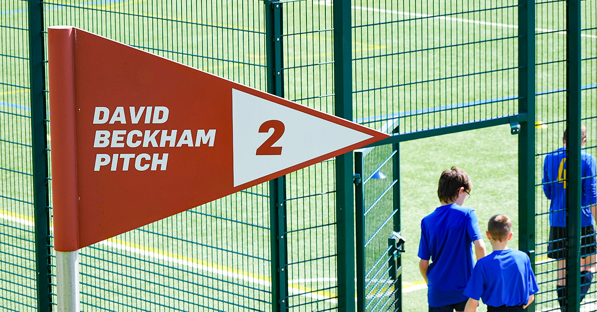 Players walk under the David Beckham Pitch sign at St George's Park