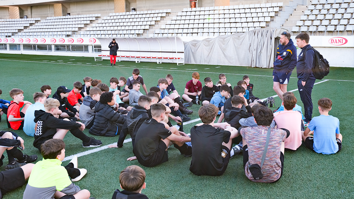 Students sit to listen to pro coaches at RCD Espanyol