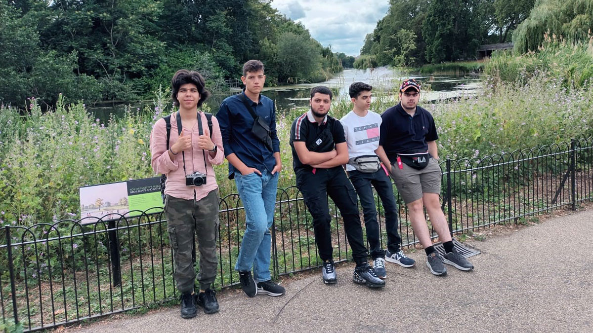 Grammar School Nicosia students pose in front of a lake in a London park.