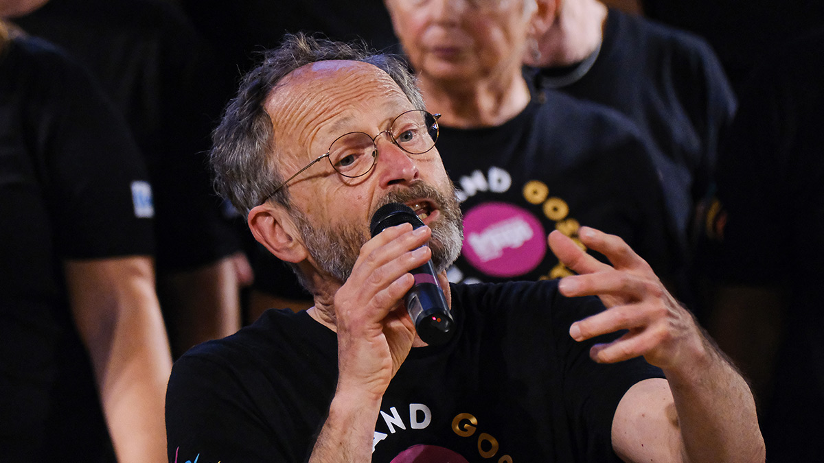 Lead singer from the Wellingborough Gospel Choir performs with the choir in the background.