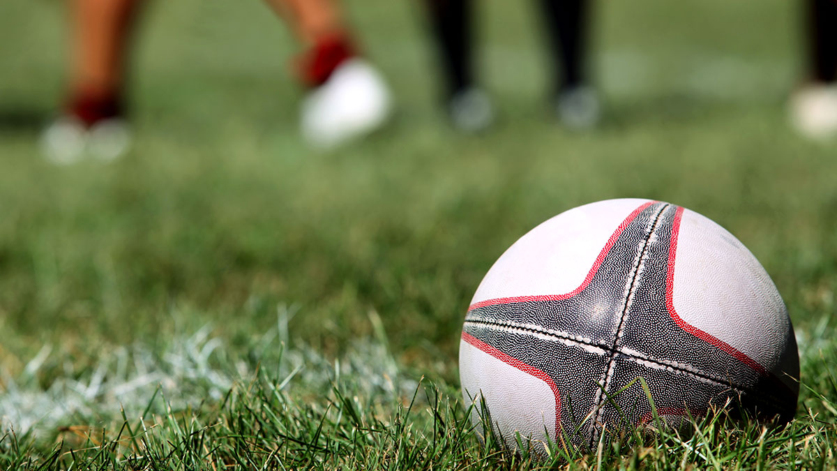 Rugby Ball placed on a pitch in the corner.