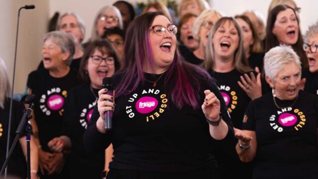 Lead lady sings in front of the Wellingborough Gospel Choir at Canongate Kirk