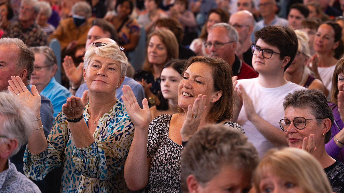 Audience enjoying a performance from Wellingborough Community Gospel Choir at Canongate Kirk in Edinburgh during the Fringe Festival