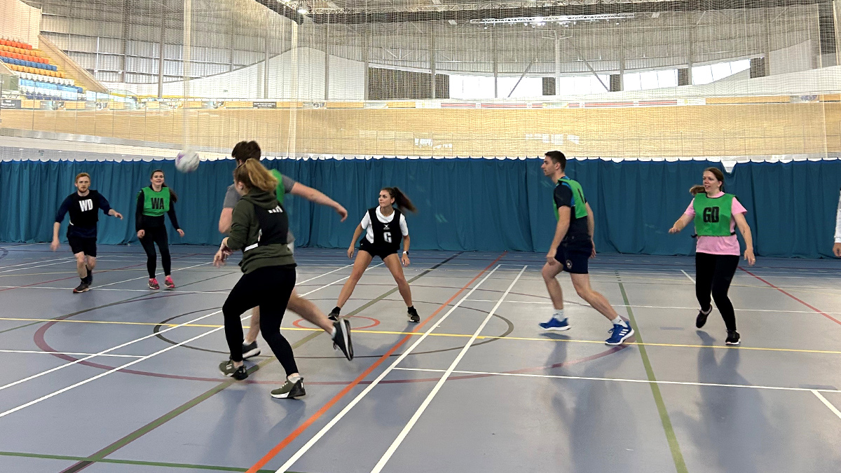 7 players on a netball court playing a match at Derby Arena